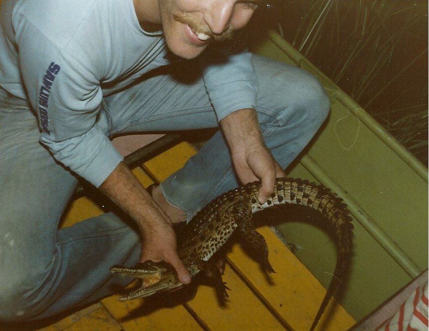 Matt Busse holds a young crocudile in the Okavango Delta, Botswana.